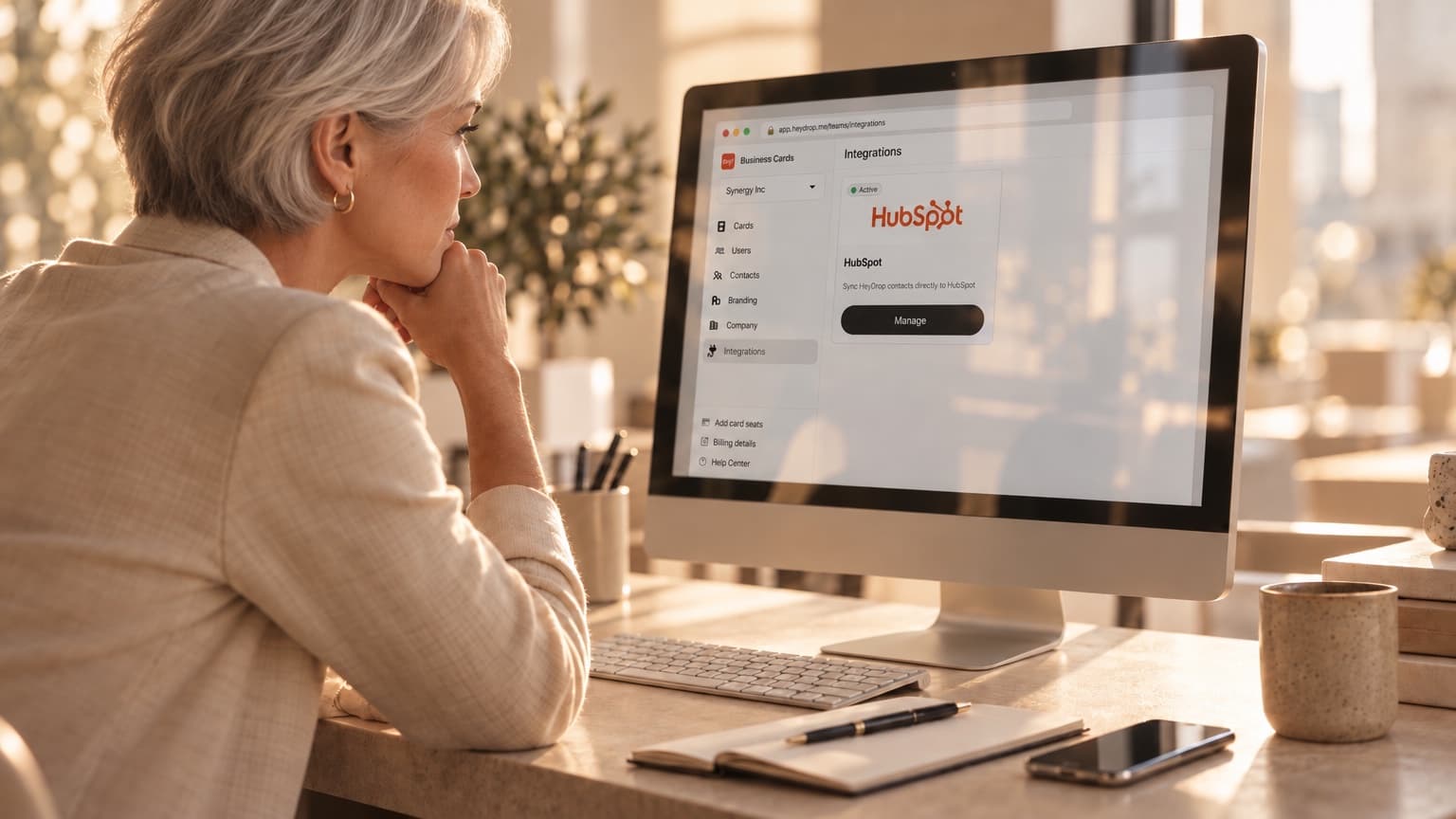 A RevOps manager looking at the HeyDrop HubSpot integration on a desktop monitor
